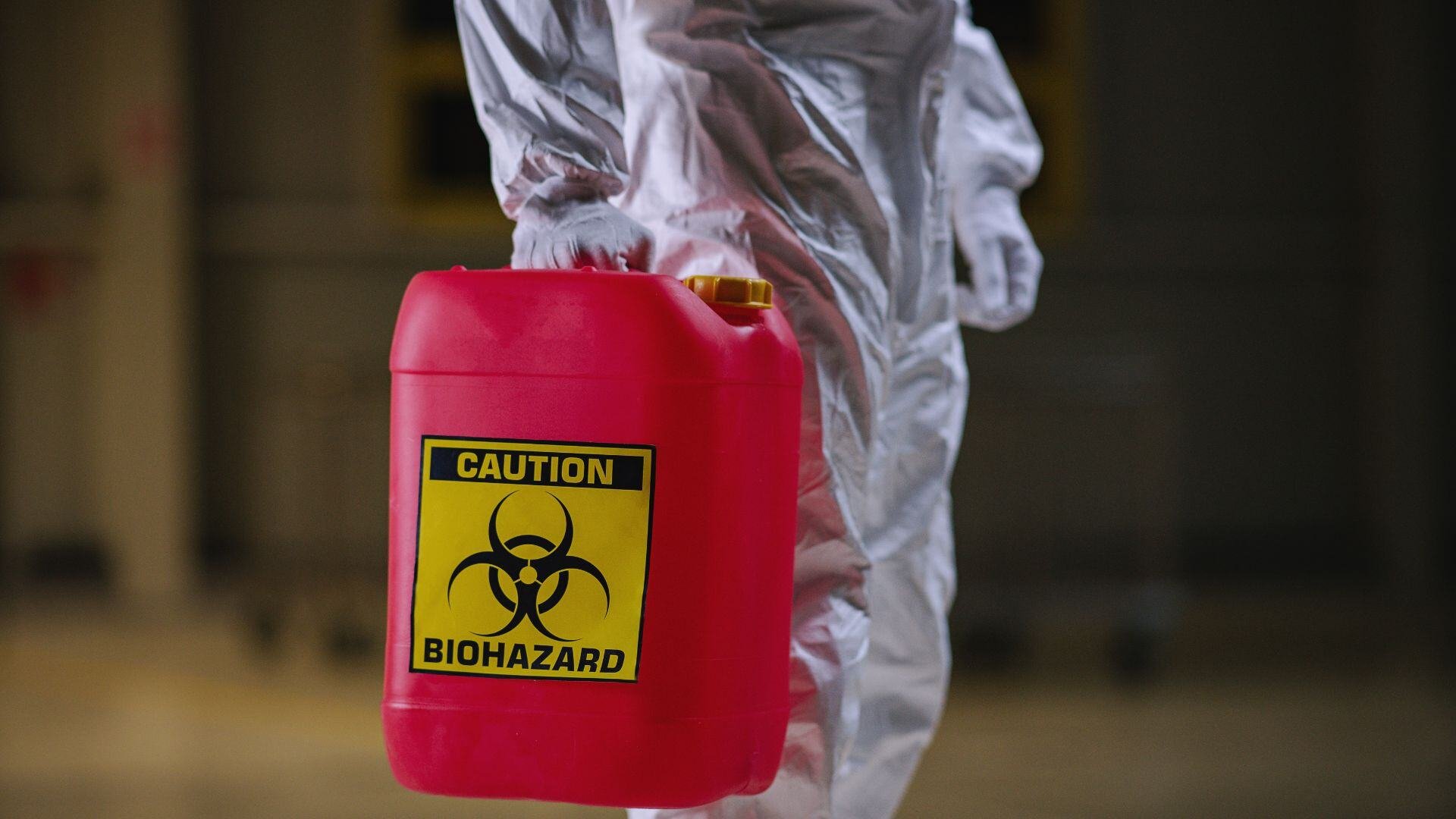 Team using protective equipment, including respiratory protection, to address chemical hazards in an industrial cleaning environment.