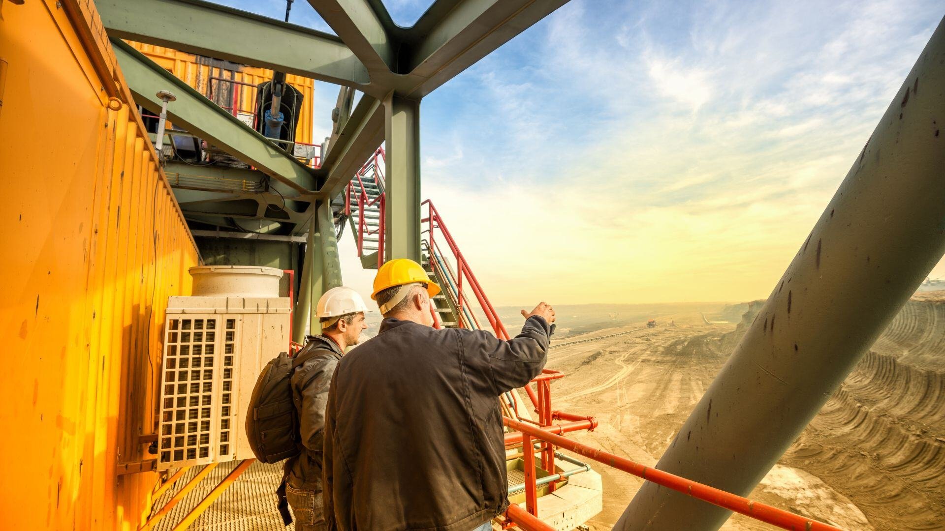 A worker in safety gear inspecting equipment at a mining site in Northern Ontario.